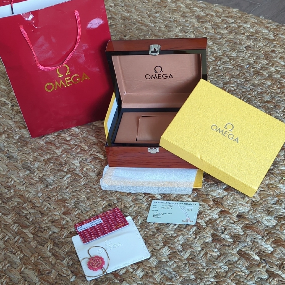 Omega Watch Packaging Set with Red and Yellow Accents